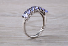 Load image into Gallery viewer, 7 stone natural Tanzanite eternity ring, oval cut Tanzanite set in 9ct white gold, one and half carats Tanzanite