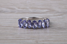 Load image into Gallery viewer, 7 stone natural Tanzanite eternity ring, oval cut Tanzanite set in 9ct white gold, one and half carats Tanzanite