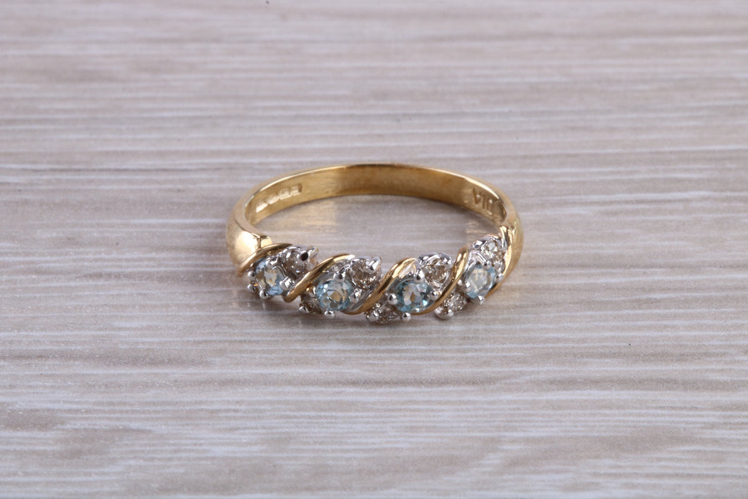 Blue topaz and diamond set ring. 9ct yellow gold with real diamonds and real topaz