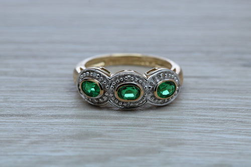 Three Emeralds and Diamonds set Yellow Gold Ring