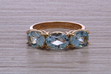Load image into Gallery viewer, Sky Blue Topaz set Yellow Gold Twist Shank Ring