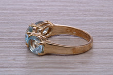 Load image into Gallery viewer, Sky Blue Topaz set Yellow Gold Twist Shank Ring
