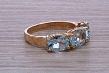 Load image into Gallery viewer, Sky Blue Topaz set Yellow Gold Twist Shank Ring