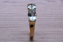 Load image into Gallery viewer, Sky Blue Topaz set Yellow Gold Twist Shank Ring
