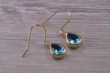 Load image into Gallery viewer, Tear Drop cut Swiss Blue Topaz Dropper Earrings set in Yellow gold