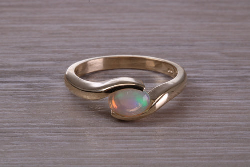 Oval cut Natural Opal set in Chunky Crossover Yellow Gold Ring