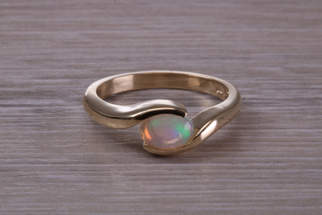 Oval cut Natural Opal set in Chunky Crossover Yellow Gold Ring