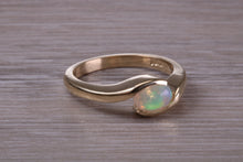 Load image into Gallery viewer, Oval cut Natural Opal set in Chunky Crossover Yellow Gold Ring