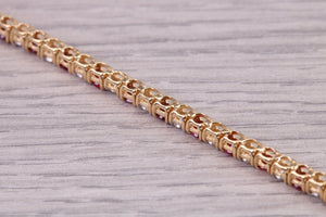 Four carats Natural Rubies and Diamonds set Solid Yellow Gold Tennis Bracelet, British Hallmarked